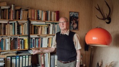 Portrait von Walter Schmidt vor einem Bücherregal